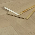 Close-up of engineered oak flooring planks showing tongue and groove