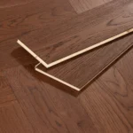 Dark oak herringbone floor planks showing tongue and groove detail