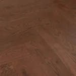 Finished dark oak wood floor in a classic herringbone pattern