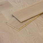 Light oak herringbone wood flooring with white-washed grai