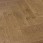 Light oak wood flooring in a herringbone pattern