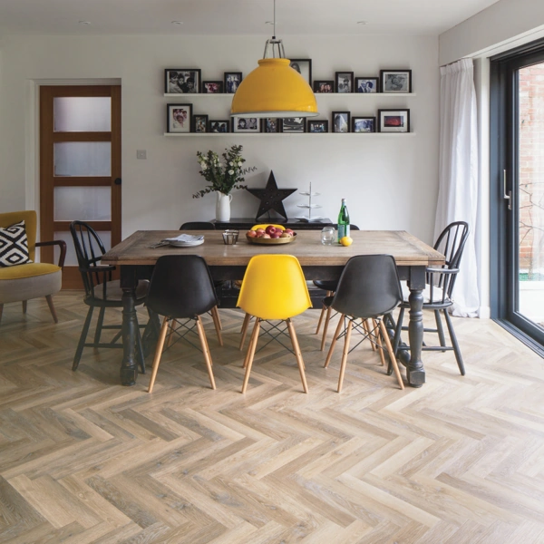 Modern dining room with herringbone wood floors.