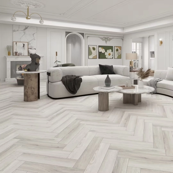 Modern white living room with herringbone wood floors.