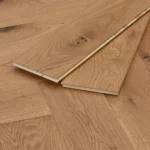 Two light oak floor planks showing tongue and groove joinery